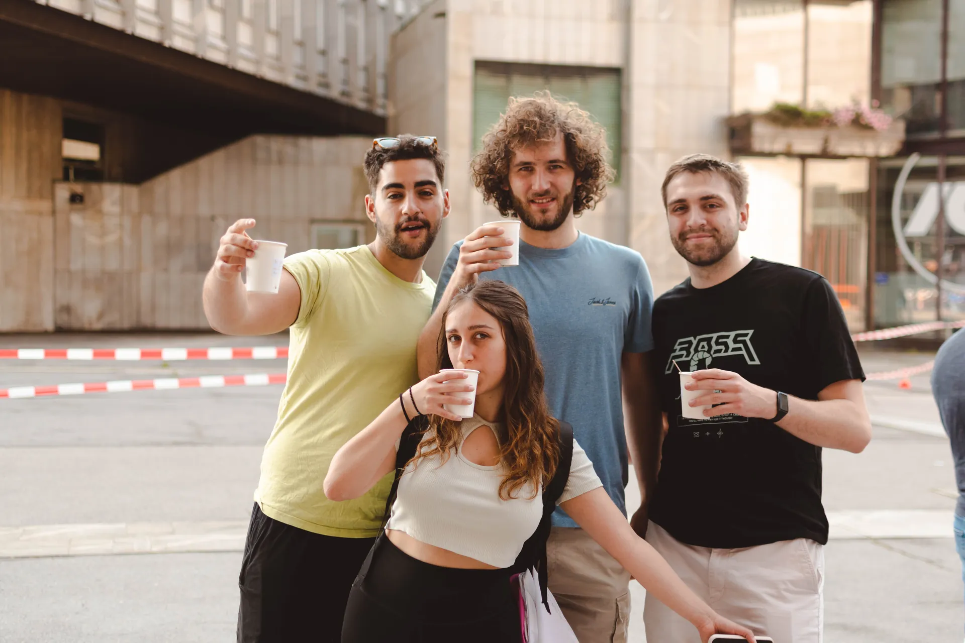 A group of students with hot coffee posing for the camera.