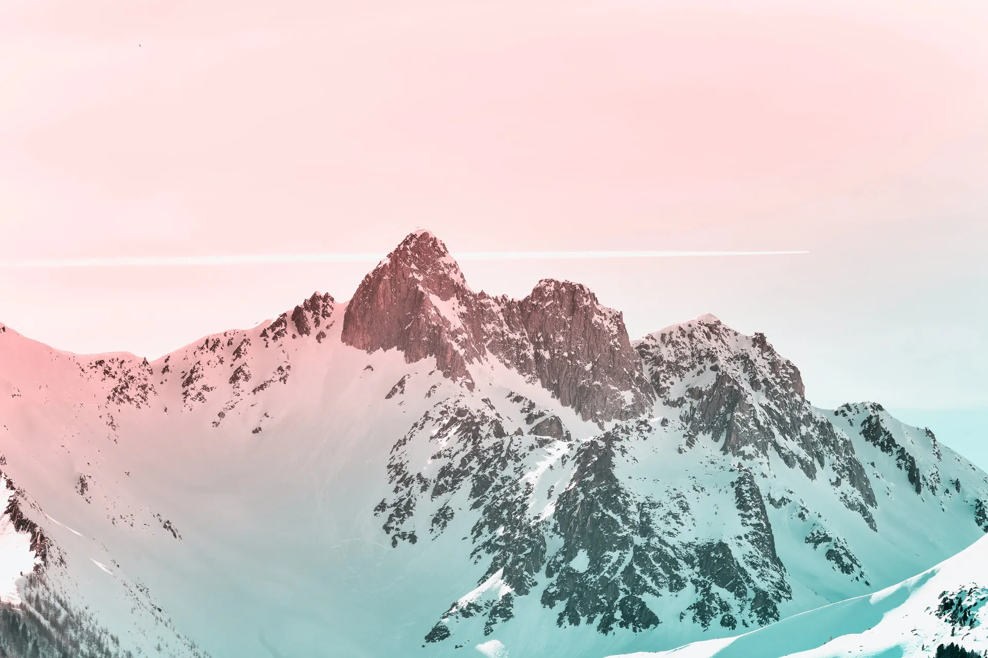 Pink and blue tinted image of a snowy mountain peak